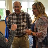 Three alumni enjoying conversation
